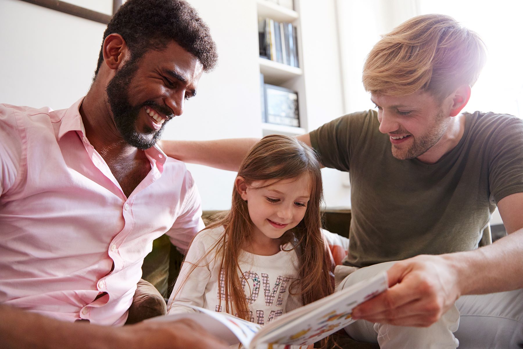 Parents reading a book to a child
