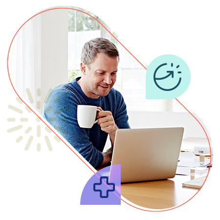 Man looking at computer while sipping on coffee