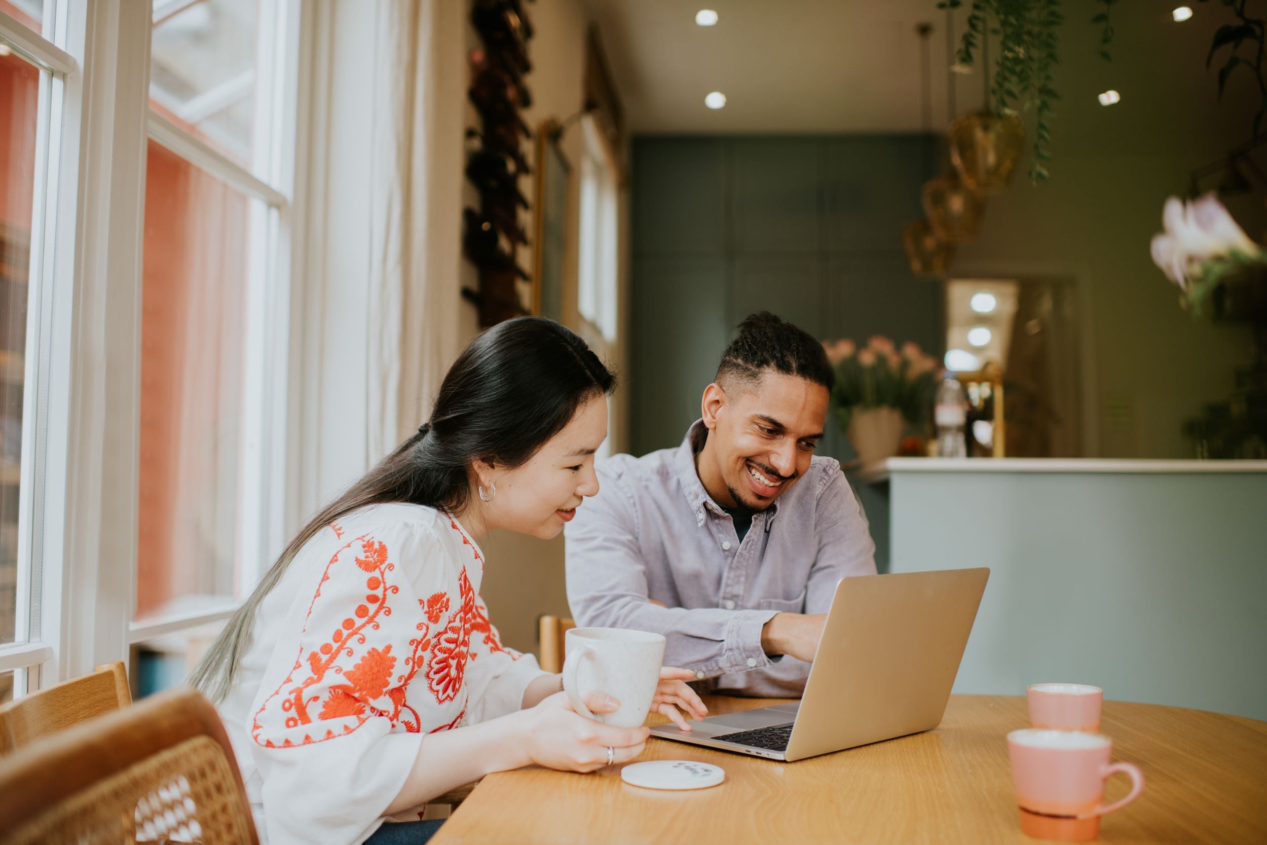 Man and woman reading from a laptop