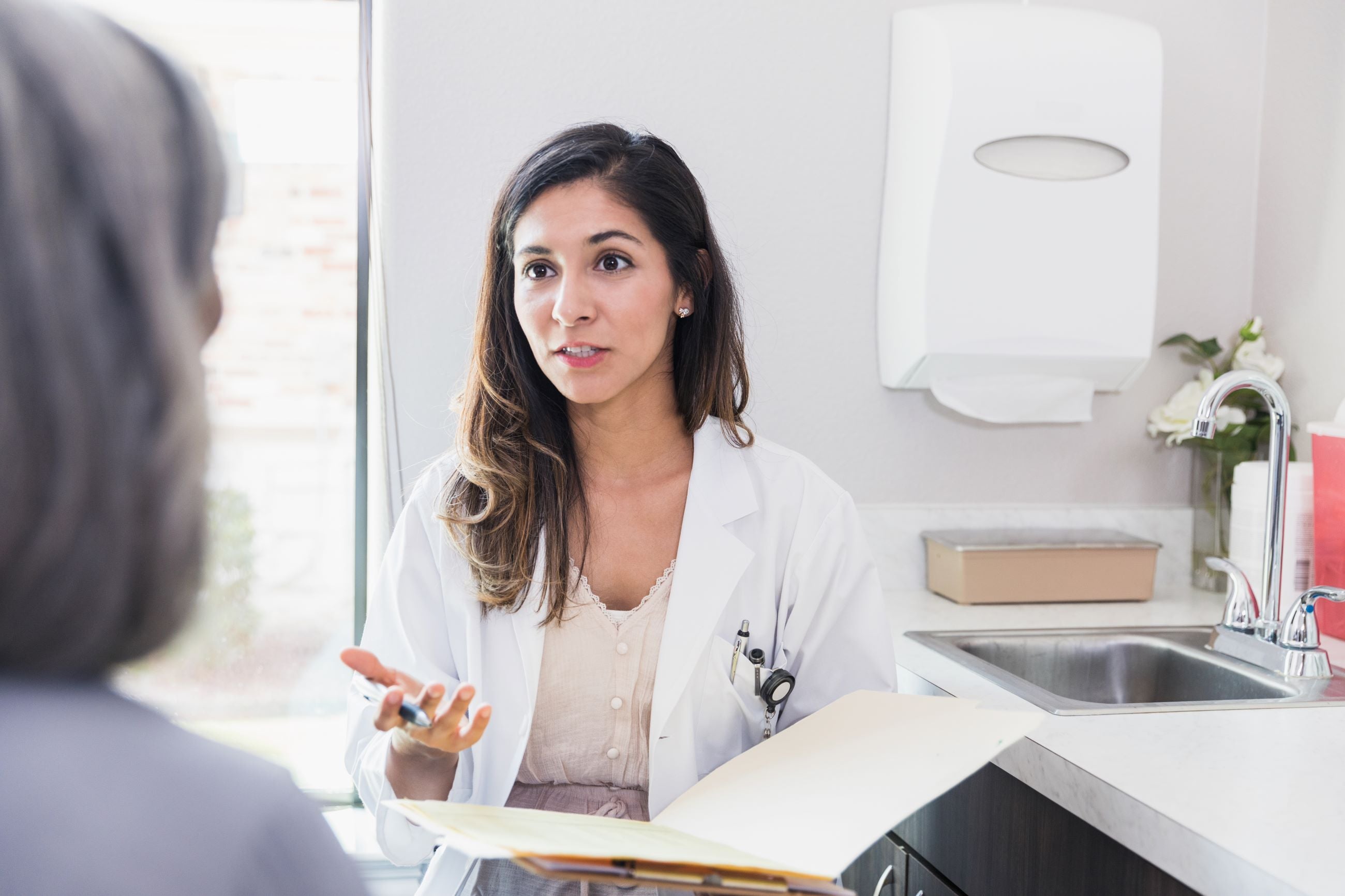 Female doctor speaking with patient