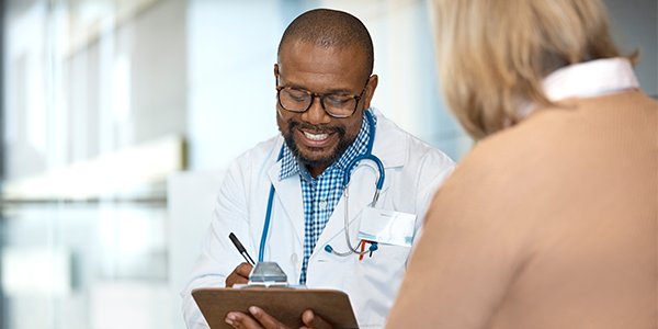 Doctor talking with patient looking at ipad