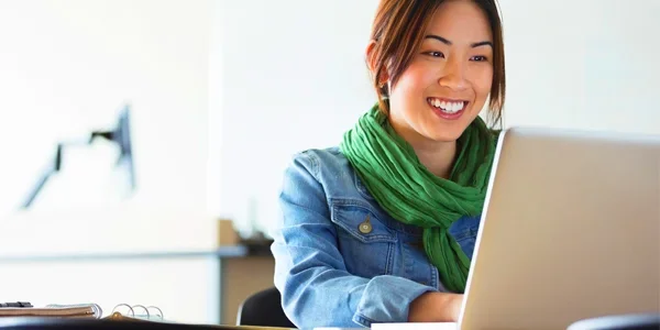 Woman on laptop smiling