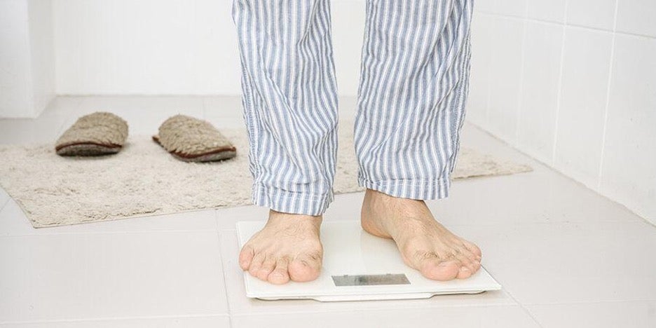 Man stepping on scale 