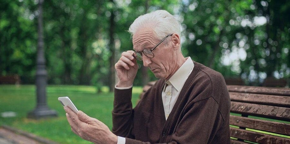 Older man looking at phone 