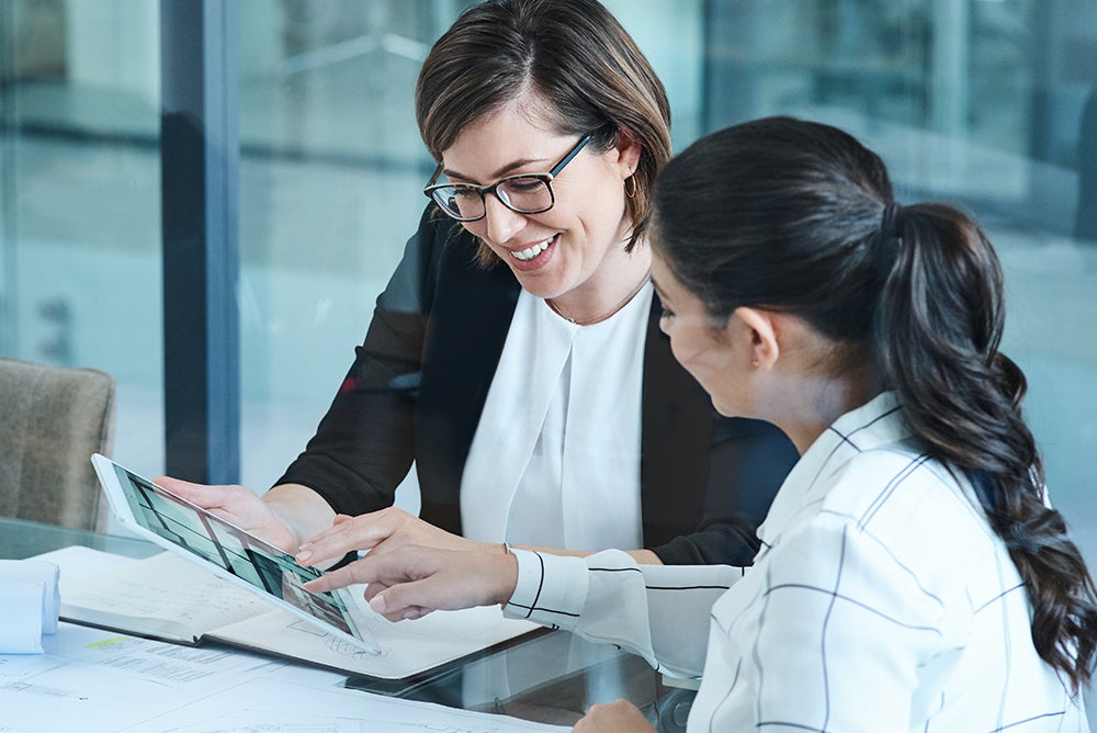 Marketers reviewing data on tablet