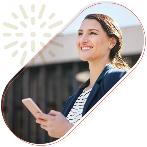 Lady looking up from her phone with a smile 