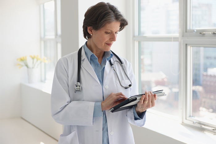 Doctor reading tablet