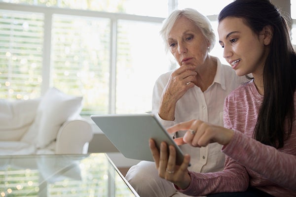 Female looking at ipad with older woman 