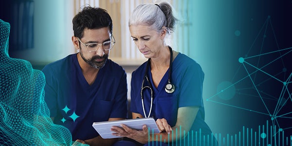 Medical professionals reviewing a tablet.