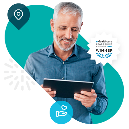 Middle-aged man smiling at tablet, with e-healthcare award badge attached.