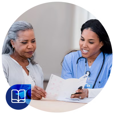 Senior woman looking at brochure with nurse