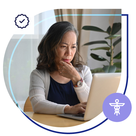 Woman using a laptop computer, thinking.