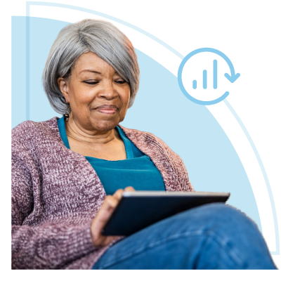 Senior woman smiling, using a tablet