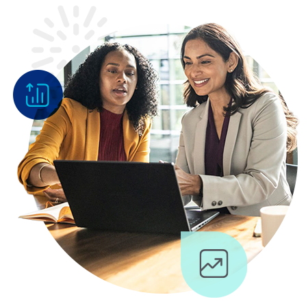 Two women discussing work on a laptop