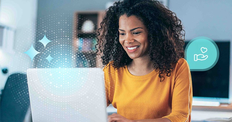 smiling woman looking at laptop with blue graphics in background