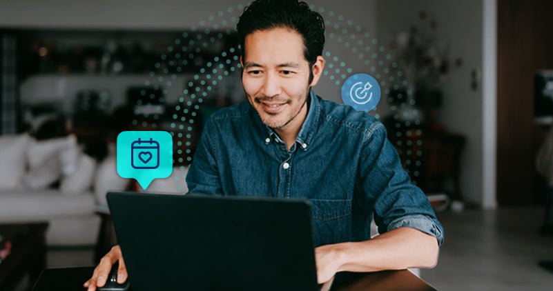 Man smiling while using a laptop with care management graphics in the background.